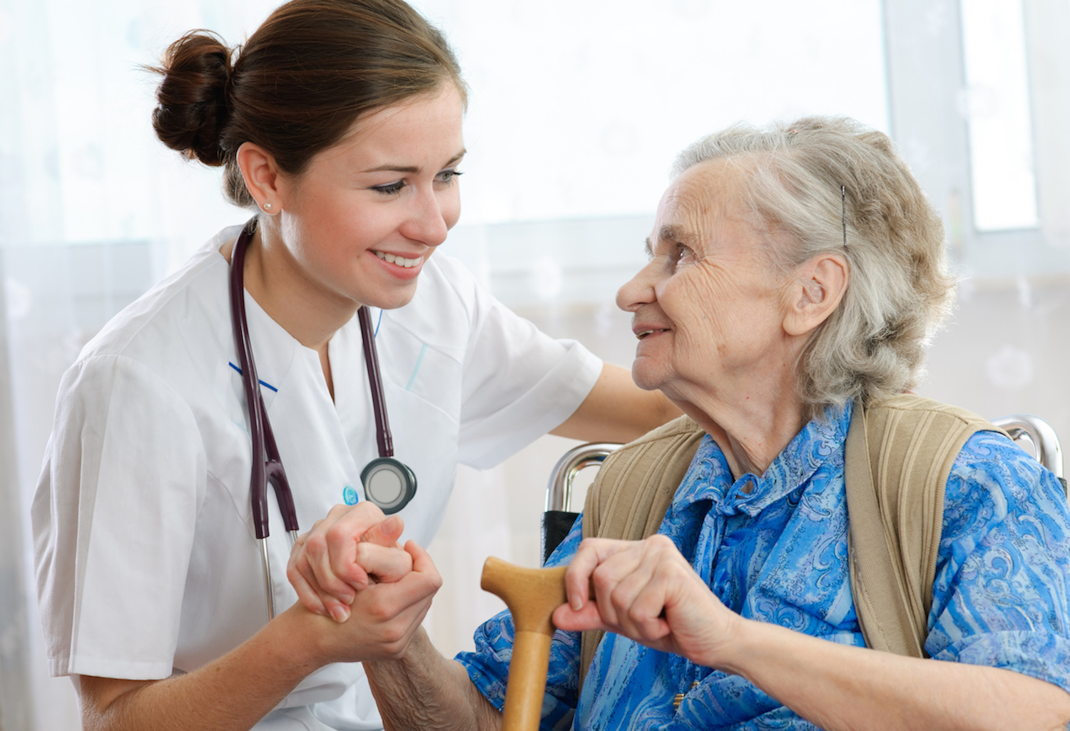Senior woman is visited by her doctor or caregiver